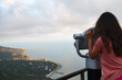 © Ann - A girl looks through a telescope at the mountains