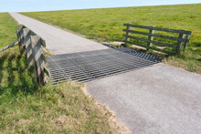 Cattle Grid Or Cattle Guard On A Seawall To Prevent Livestock From Passing Along A Road Which Penetrates The Fencing Surrounding An Enclosed Piece Of Land Or Border.
