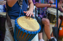 Young Musician Playing Drums On Music Festival.  Djembe African Drum. Drummer At The Concert. 