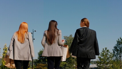 Beautiful office mangers women walking down the street to the lunch time in front of the camera taking video from the back