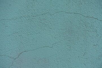 Wall Mural - Closeup of old dusty mint colored painted wall with cracks