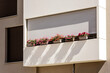 © Maryana - Balcony with Flowers and External Shutters. Modern Decorated Balcony with Blinds on Facade. Balconies Roller Blinds.