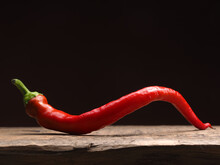 Spicy Organic Red Chili Pepper On A Rustic Wooden Table, Food Ingredients, Space For Text, Dark Background