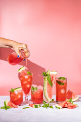 Wall Mural - Different elegant glasses with watermelon cocktail on light gray