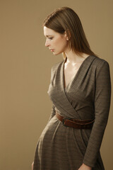 Serie of studio photos of young female model in brown tweed dress, autumn winter fashion collection.