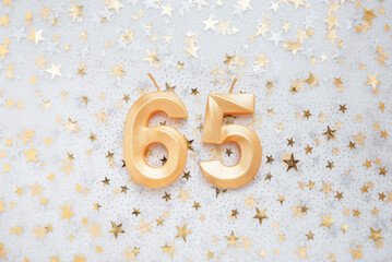 Wall Mural - Number 65 sixty five golden celebration birthday candle on Festive Background. sixty five years birthday. concept of celebrating birthday, anniversary, important date, holiday