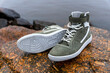 new fashionable high youth sneakers on a stone background