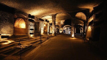 Tunnels of catacombs underground with burial holes