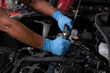 © Montri - Auto mechanic working and repair on car engine in mechanics garage. Car service. male mechanic repairs car in garage. Car maintenance and auto service garage concept.