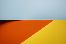 Abstract Background Of Gray, Red And Yellow Colors With Shadow. Copy Space. Top View. 