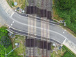 Overhead view of a rural level crossing over a main railway line. No people.