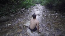 The Person Waving His Wet Hair In The Stream. Slow Motion.
The Man Washing His Hair In The Creek Raises His Head And Shakes It. The Waters Are Splashing.
