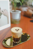Fototapeta Kwiaty - cup of coffee on brown wooden table