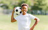 Fototapeta Sport - happy multicultural hispanic soccer player outdoor in sunny day