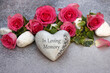 Grave decoration: The text In Loving Memory on a stone heart with roses.