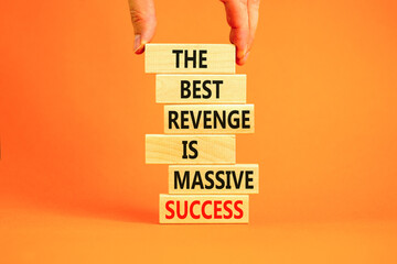 Revenge or success symbol. Concept words The best revenge is massive success on wooden blocks. Bussinesman hand. Beautiful orange background. Business and revenge or success concept. Copy space.