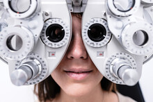 Woman In Phoropter During Eyesight Examination