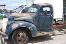 Rusty Blue Old Pick Up Truck In Car Lot