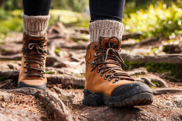 Hiking boot. Legs on mountain trail during trekking in forest