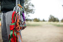 Midsection Of Man Carrying Rock Climbing Equipment On Field