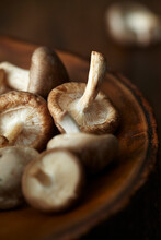 Close-up Of Mushrooms In Wooden Plate On Table