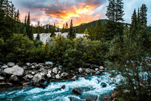 Scenic View Of Stream Amidst Forest Against Dramatic Sky