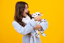 Teen Girl Child In Casual Wear Holding Plush Toy Isolated On Yellow Background, Happy Childhood. Amazed Teen Girl. Child In Pajamas, Good Morning. Excited Expression, Cheerful And Glad.