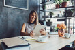 © Cavan Images - Happy businesswoman using tablet computer while sitting at table in home office