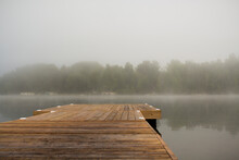 Wooden Pier Over Lake Against Sky During Foggy Weather