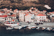 © Cavan Images - Tilt-shift image of boats moored at lake by houses in town