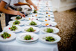 © Cavan Images - Workers serving salad in plates on table