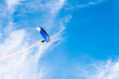 © Cavan Images - Low angle view of hiker powered paragliding against sky