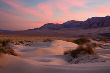 Majestic View Of Sand Dunes Against Mountains And Dramatic Sky At Death Valley National Park