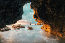 Scenic View Of Ocean Against Sky Seen Through Cave