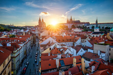 St. Vitus Cathedral, Prague Castle And Lesser Town Panorama. View Of St. Vitus Cathedral, Prague Castle And Red Roofs. Prague, Czech Republic. View Of Prague Castle At Sunset. Prague, Czech Republic