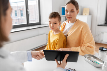 Canvas Print - medicine, healthcare and pediatry concept - smiling mother with little son and doctor with tablet pc computer at clinic