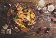 Overhead View Of Chicken With Wine And Christmas Decorations On Wooden Table