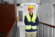 © Syda Productions - architecture, construction business and building concept - happy smiling male builder in helmet, goggles and safety west at office