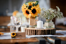 Flowers With Candles And Drinking Glasses Arranged On Table During Wedding Reception