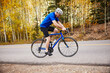 © Cavan Images - Side view of senior man riding bicycle while exercising on country road