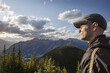 © Cavan Images - Side view of man looking away while standing on mountain against sky at Banff National Park