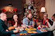 © DC Studio - Big diverse family celebrating christmas, talking at festive dinner table, eating traditional winter holiday food. Xmas celebration at beautiful decorated place, fir tree, fireplace on background