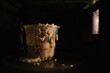 © Cavan Images - Close-up of food in measuring cup on table at darkroom