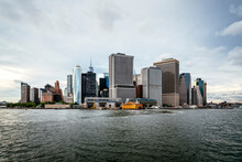 Modern Buildings By Hudson River Against Cloudy Sky In City