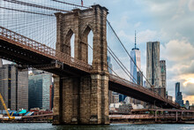 Low Angle View Of Brooklyn Bridge Over East River Against Modern Buildings In City
