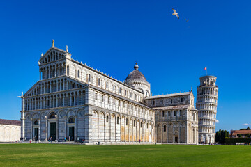 Pisa Cathedral and the Leaning Tower in a sunny day in Pisa, Italy. Pisa Cathedral with Leaning Tower of Pisa on Piazza dei Miracoli in Pisa, Tuscany, Italy.