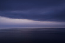 Scenic View Of Seascape Against Cloudscape At Dusk