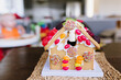 © Cavan Images - Close-up of gingerbread house on wooden table at home during Christmas