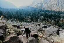 Man Bouldering Down Cliff In Yosemite