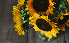 High Angle View Of Sunflowers In Vase On Wooden Table